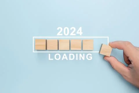 2024 New Year Loading. Loading bar with wooden blocks 2024 on blue background Stock Photos