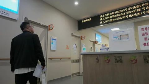 2024 Oct 13. Shanghai, Low angle wide shot of man in empty clinic corridor Stock Footage 333669525