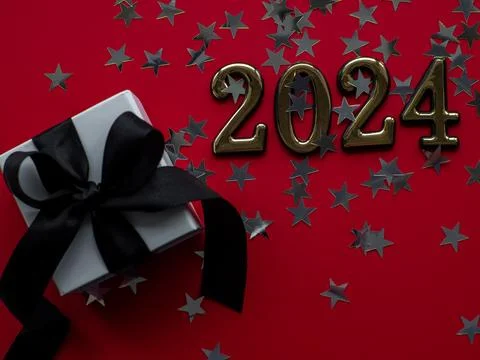 2024 on red background with gift box and silver stars Stock Photos