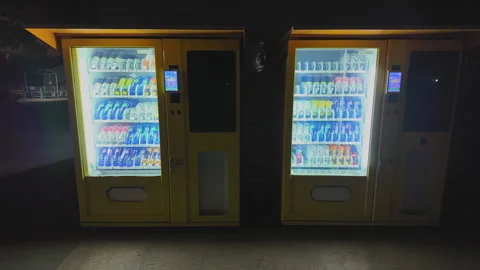 2025 Jan 23. Shanghai, Two illuminated yellow beverage vending machines Stock Footage 334925972