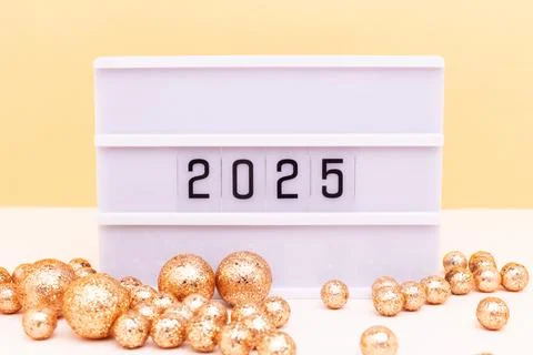 2025 New Year concept. Lightbox with numbers and shiny balls. Stock Photos