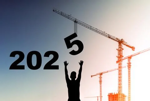 2025 year concept. Construction worker and crane on the backdrop of sunset and Stock Photos