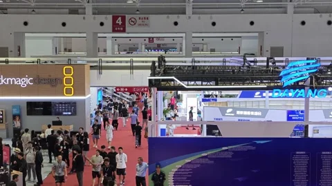2026 Aug 20, Beijing.BIRTV Crowd of business attendees walks through indoor tech Stock Footage 344810728