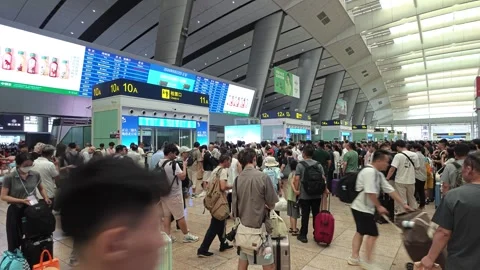 2026 Aug 22, Beijing. Crowd of passengers with luggage queuing Stock Footage 344840065