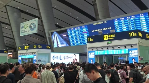 2026 Aug 22, Beijing. Dense crowd of travelers queuing to board Stock Footage 344840092