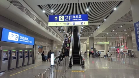 2026 Aug 23, Shanghai. Passengers ascend escalator to second-floor departures Stock-Footage 344842546