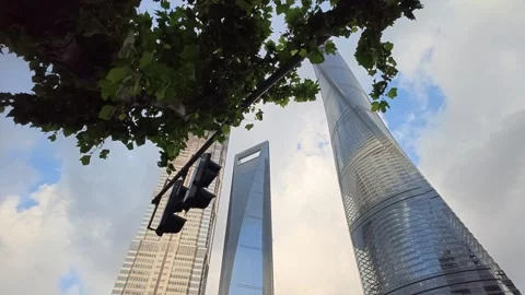 2026 Aug 27, Shanghai. Low angle view of modern glass skyscrapers framed by Vidéo 344852741