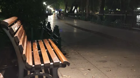 2026 Jul 01, Hangzhou. Empty wet park benches, reflective waterfront walkway Stock Footage 338393221