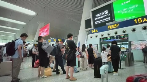 2026 Jul 03, Hangzhou. train station Passengers Queue with Luggage Stock Footage 338426661