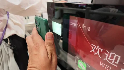 2026 Jul 04. Customer Scanning QR Code for Mobile Payment at Checkout Counter Stock Footage 339086607