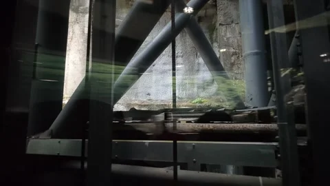 2026 Jul 15, Wulong. Moving glass elevator view of industrial shaft, steel truss Stock Footage 340524358
