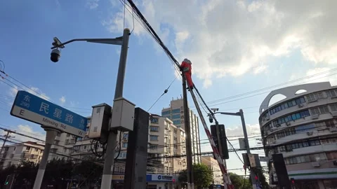 2026 Jul 25, Shanghai.  lineman climbs wooden pole to work Stock Footage 344740976