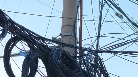 2026 Jul 25, Shanghai. Tangled thick black cables coiled around a gray Stock Footage 344741024