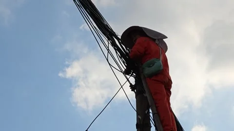 2026 Jul 25, Shanghai. Utility lineman climbs wooden pole to work Stock Footage 344740978