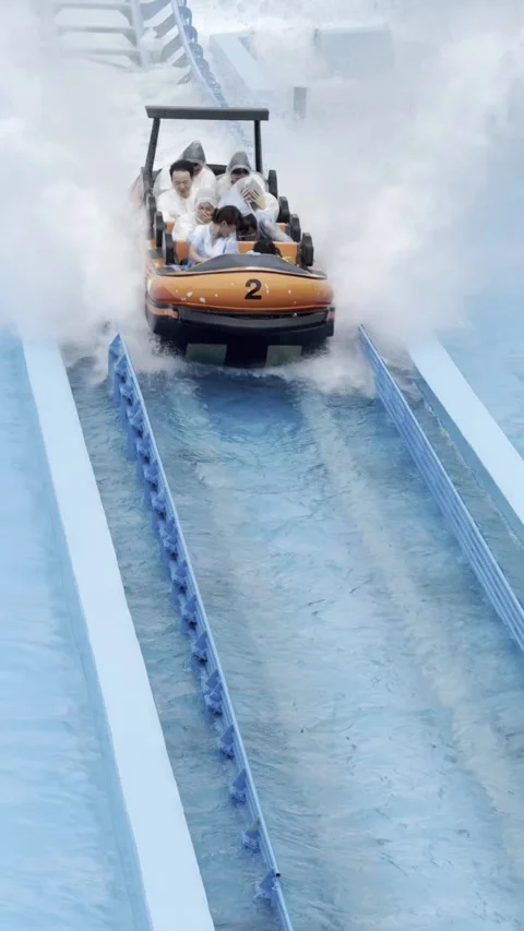 2026 Jun 06, ZhuHai. Happy Family Riding Orange Water Slide Boat Through Stock-Footage 336521353