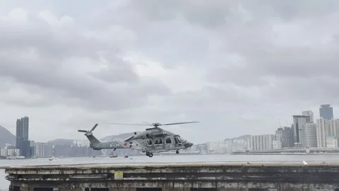 2026 Jun 07, Hong Kong. Gray military helicopter B-LVH lands on concrete pier Stock Footage 336521334