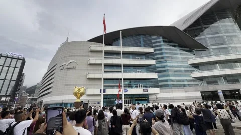 2026 Jun 07, Hong Kong. Crowd watches flag raising Video stock 336521339