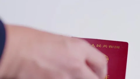2026 Jun 09, China. Hand Holding Red Chinese Passport and Marriage Certificates Stock Footage 336546976