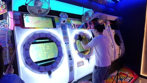 2026 Jun 29, Shanghai. A man playing a music arcade game Stock Footage 337880090