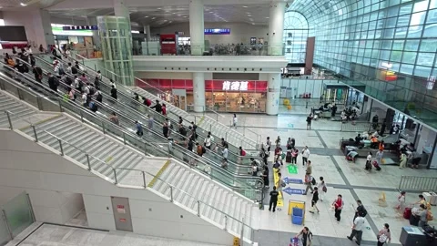 2026 Jun 30, Shanghai. Busy modern transit station, crowds on escalators Stock Footage 338231899