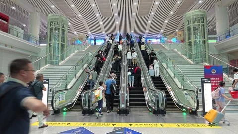 2026 Jun 30, Shanghai. Busy transit hub passengers, escalators Stock Footage 338232108