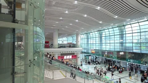 2026 Jun 30, Shanghai. High-angle view of busy modern train station concourse Stock Footage 338231876