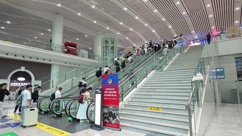 2026 Jun 30, Shanghai. Passengers boarding parallel escalators Stock Footage 338232097