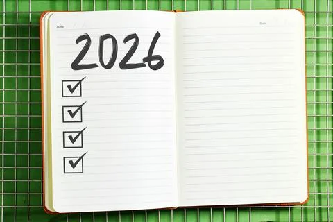 2026 Planning Notebook With Checklists On Lined Pages Against A Green Grid Backg Stock Photos