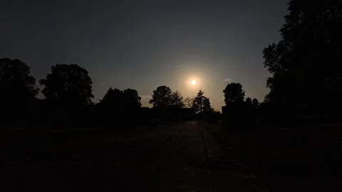 2026 Solar eclipse moving slowly across glowing silhouette trees making stone 스톡 동영상 343080262