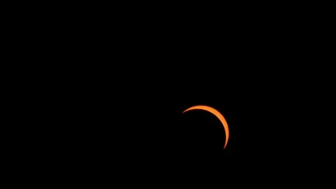 2026 Solar eclipse time lapse sun covered by passing moon glowing orange Stock Footage 343079819