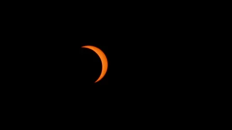 2026 Solar eclipse time lapse sun covered by moon passing glowing orange Stock Footage 343079840