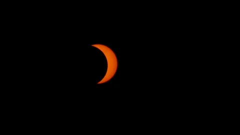 2026 Solar eclipse time lapse sun covered by moon and cloud passing glowing Stock Footage 343080926