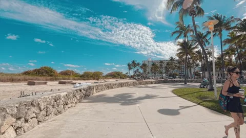 2026 Spring Break Miami Beach bike ride on Ocean Drive pedestrian pathway Stock Footage 331309271