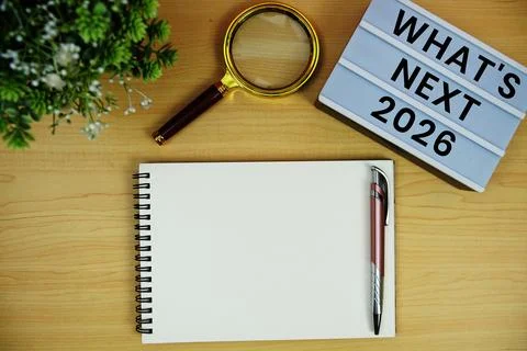 2026 What's Next? text with notepad and magnifying glass on wooden background Stock Photos
