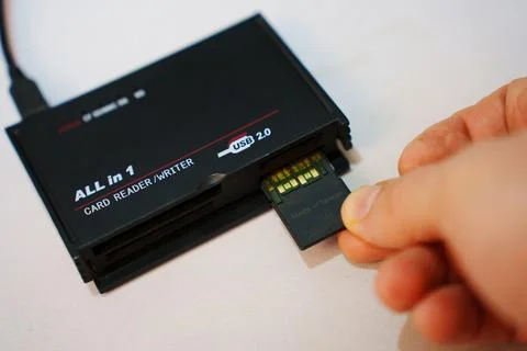 2026.04.26, Russia. Inserting memory card into USB reader Stock Photos