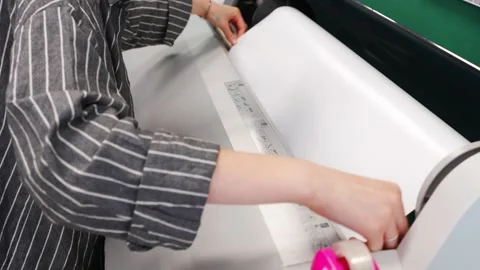 2026.06.18, Russia. Worker laminates large photo print on wide format machine Stock Footage 337460079