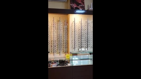 2026.09.29, Russia. Rows of eyeglass frames lit on optical store shelves Stock Footage 346897737