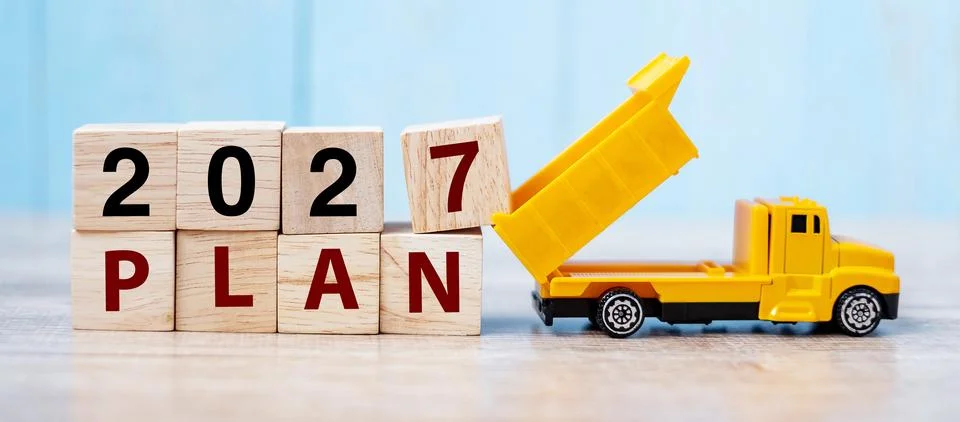 2027 Plan cube blocks with miniature truck or construction vehicle. New Sta.. Stock Photos