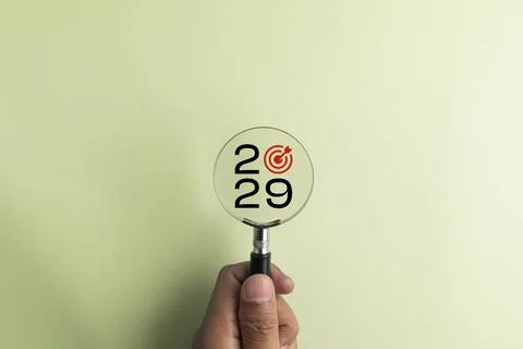 2029 displayed inside a magnifying glass with a target symbol, representing.. Fotos de archivo