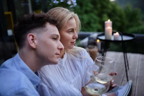 A young couple clinking with wine outdoors, weekend away in tiny house in countryside, sustainable living. xkwx love, wine, couple, woman, man, outdoor, happy, terrace, romance, romantic, together, young, drink, glass, person, smiling, caucasian, celebration, lifestyle, garden, party, relationship, two, alcohol, cheerful, vacation, tourism, closeness, date, honeymoon, newlyweds, lover, positive, togetherness, drinking, champagne, evening, holding, tiny house, holiday, nature, off beat, relax, meditation, digital detox, candle, hygge, travel, weekend away