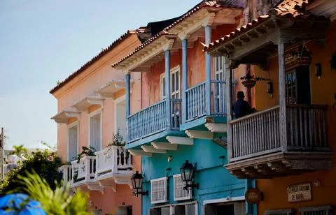 A beautiful shot of a colorful building in the historic part of Cartagena xkwx architecture, balcony, beautiful, building, cartagena, city, colorful, columbia, destination, exterior, facade, historic, historical, history, landmark, old, street, town, travel, urban, view, wall, window