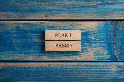 Plant based sign written on two wooden pegs placed over textured blue wooden background. xkwx vegan, plant, based, quality, vegetarian, plant based, healthy, trend, food, certified, diet, green, organic, nourishment, product, eco, nutrition, sustainable, label, protein, natural, badge, suitable, friendly, environmental, tag, environment, sign, text, free, conceptual, wooden, blue, background, peg