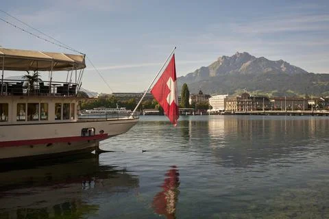 Ship with flag floating in river in mountainous town Lucerne, Canton of ...