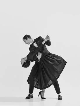 20s-30s era. Beautiful young couple, man and woman in elegant clothes dancing Stock Photos