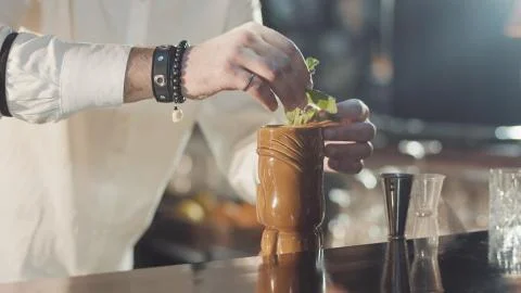20s bartender is preparing cocktail in a night bar Stock Photos
