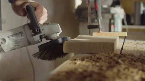 20s bearded woodworker using brashing machine tool and checking quality of work Stock Footage 76097493