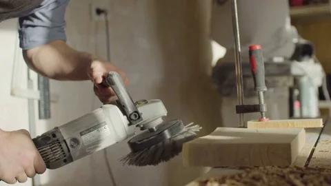 20s bearded woodworker using brashing machine tool and checking quality of work Video stock 76097994