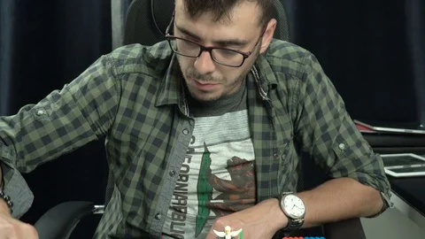 20s guy is playing in plastic construction toys at home 4k close-up. Stock Footage 79673148