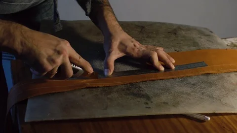 20s young Man working in his workshop with leather using crafting DIY tools Stock Footage 71388703