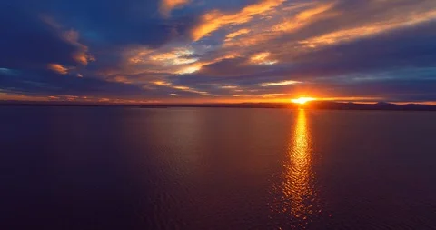 21 Revealing the lake up to dramatic sunset above the peninsula. aerial 4k Stock Footage 85669401